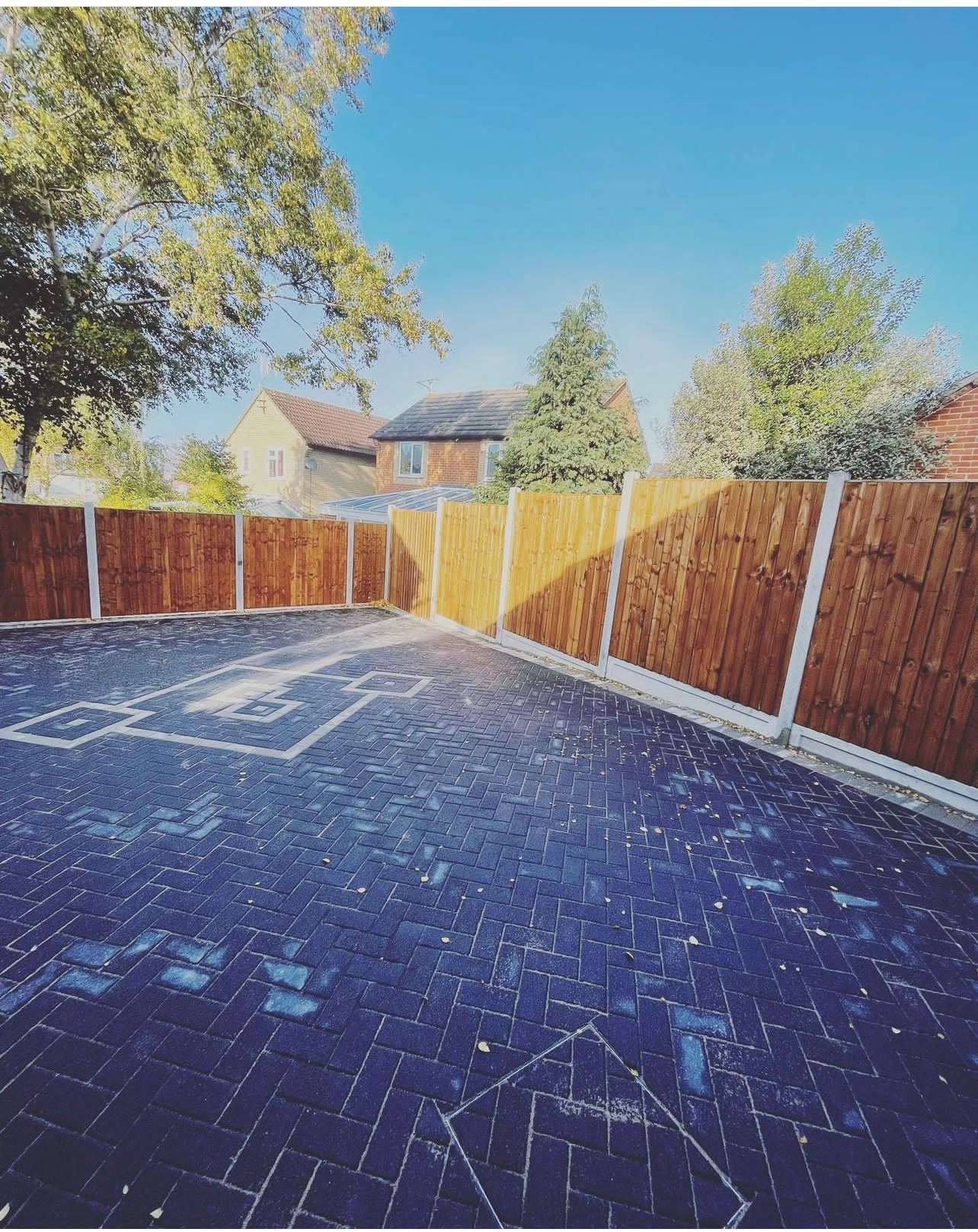 Charcoal block paving driveway with fencing