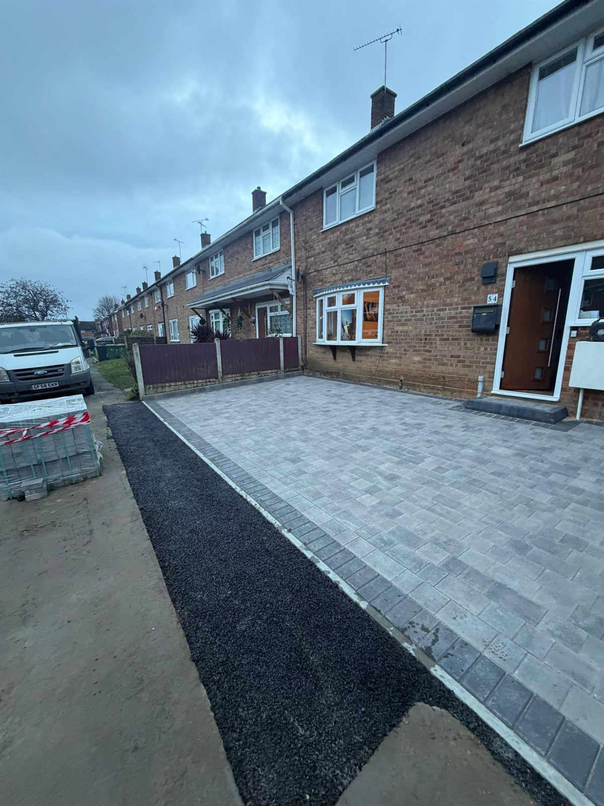 Block paving driveway and path alongside a brick home