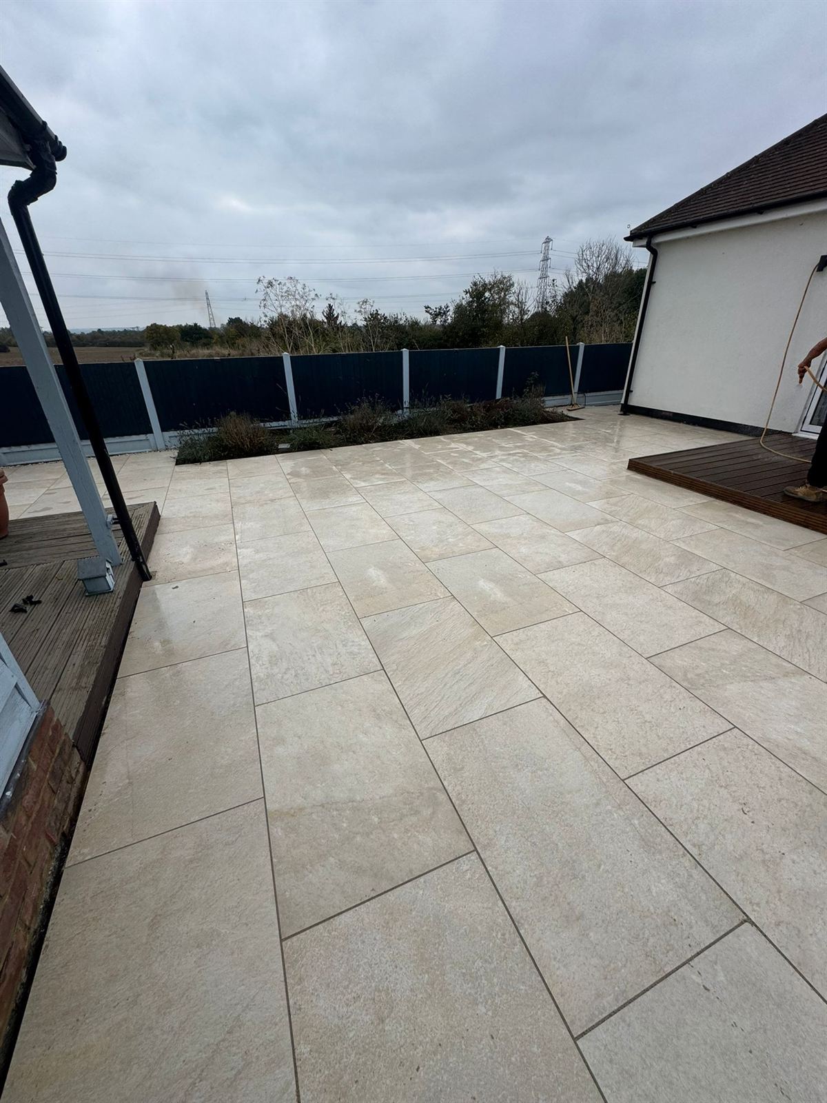 Large cream sandstone patio in a landscaped garden